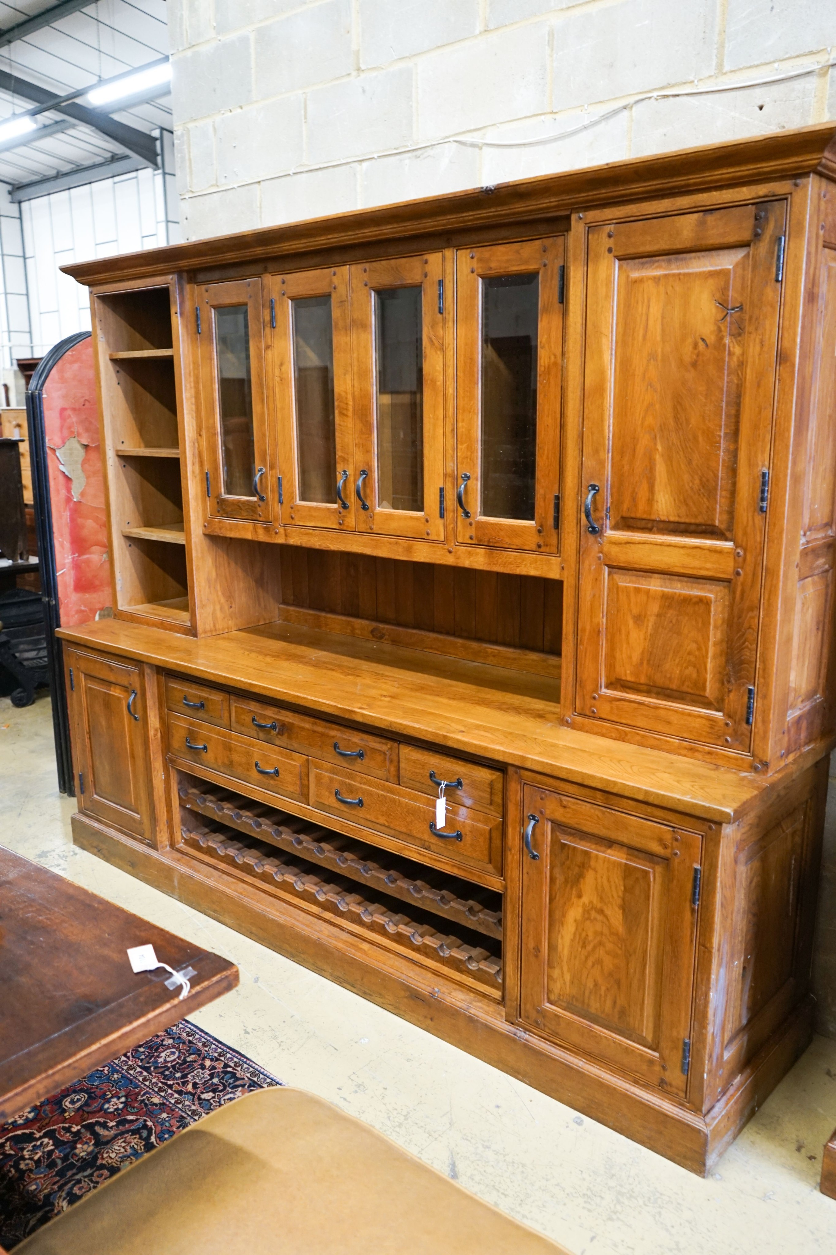A large reproduction oak dresser with wine bottle storage, length 244cm, depth 60cm, height 201cm